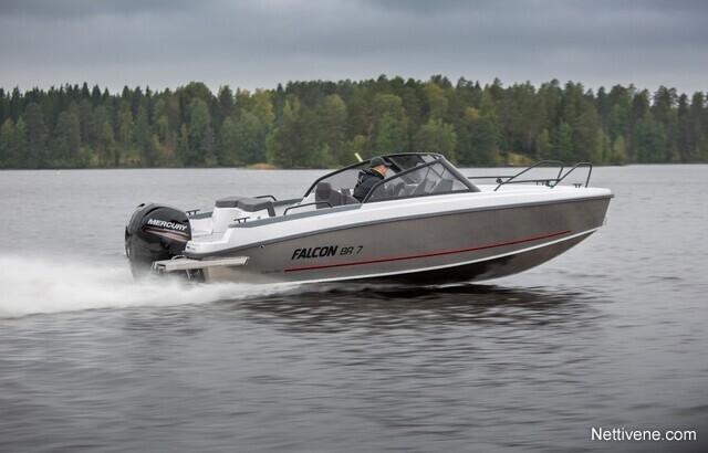 A Falcon BR 7 boat speeds across a lake, showcasing its sleek design and Mercury motor against a forested backdrop.